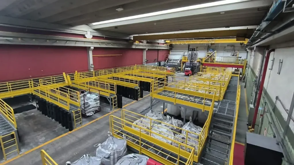 Plataforma metálica elevada com guarda-corpos amarelos sobre linha de produção — Coca-Cola FEMSA, Jundiaí/SP
